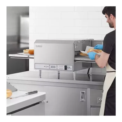 Person using commercial conveyor toaster oven